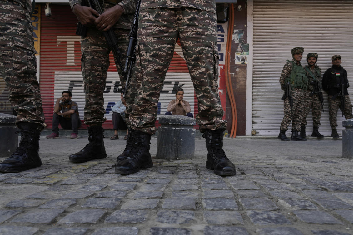 Indian security force soldiers stand guard as Kashmir civilians watch during a flag-off ceremony of the Yashasvini High-Altitude (CRPF) Bike Expedition in Srinagar, Indian controlled Kashmir, Tuesday, Sept. 23, 2025. (AP Photo/Mukhtar Khan)