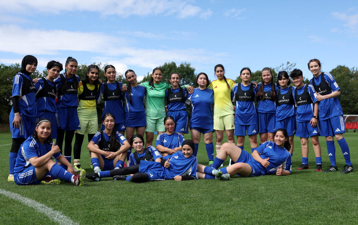 Members of the Afghan Women’s Refugee team pose for a team group during a selection camp at St. George’s Park, Burton upon Trent in Britain on Aug. 26, 2025. (Reuters)
