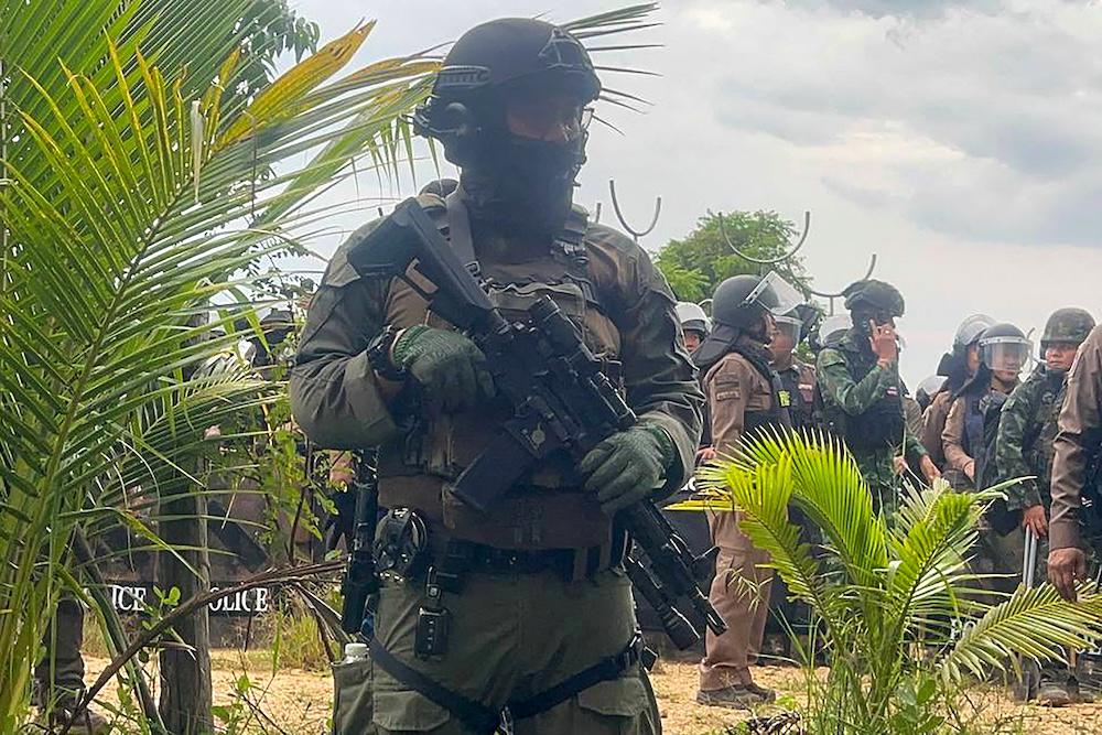 Above, a Thai soldier stands guard in a disputed area along the Cambodia-Thailand border in Banteay Meanchey province on Sept. 17, 2025. (Agence Kampuchea Press/AFP)