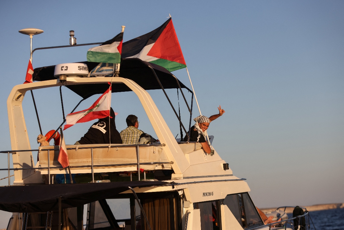 A woman gesture aboard a boat, part of the Global Sumud Flotilla aiming to reach Gaza and break Israel's naval blockade, as it sails off Crete island, Greece. (Reuters)