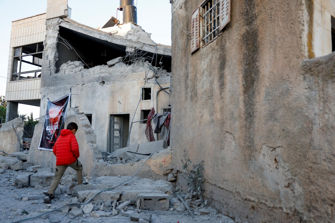A Palestinian child walks near the house of one of the two Palestinian gunmen who killed several Israelis in a shooting in Jerusalem, after it was demolished by the Israeli army during an operation, in Al-Qubayba near Ramallah, in the Israeli-occupied West Bank, September 27, 2025. (Reuters)