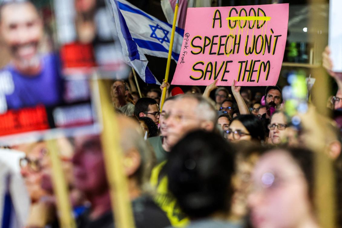 A demonstrator holds a sign referencing the Israeli prime minister’s speech at the UNGA the previous day, during an anti-government protest organized by the families of the Israeli hostages taken captive in Gaza, calling for a ceasefire and for action to secure the hostages’ release, in Tel Aviv on Sept. 27, 2025. (AFP)