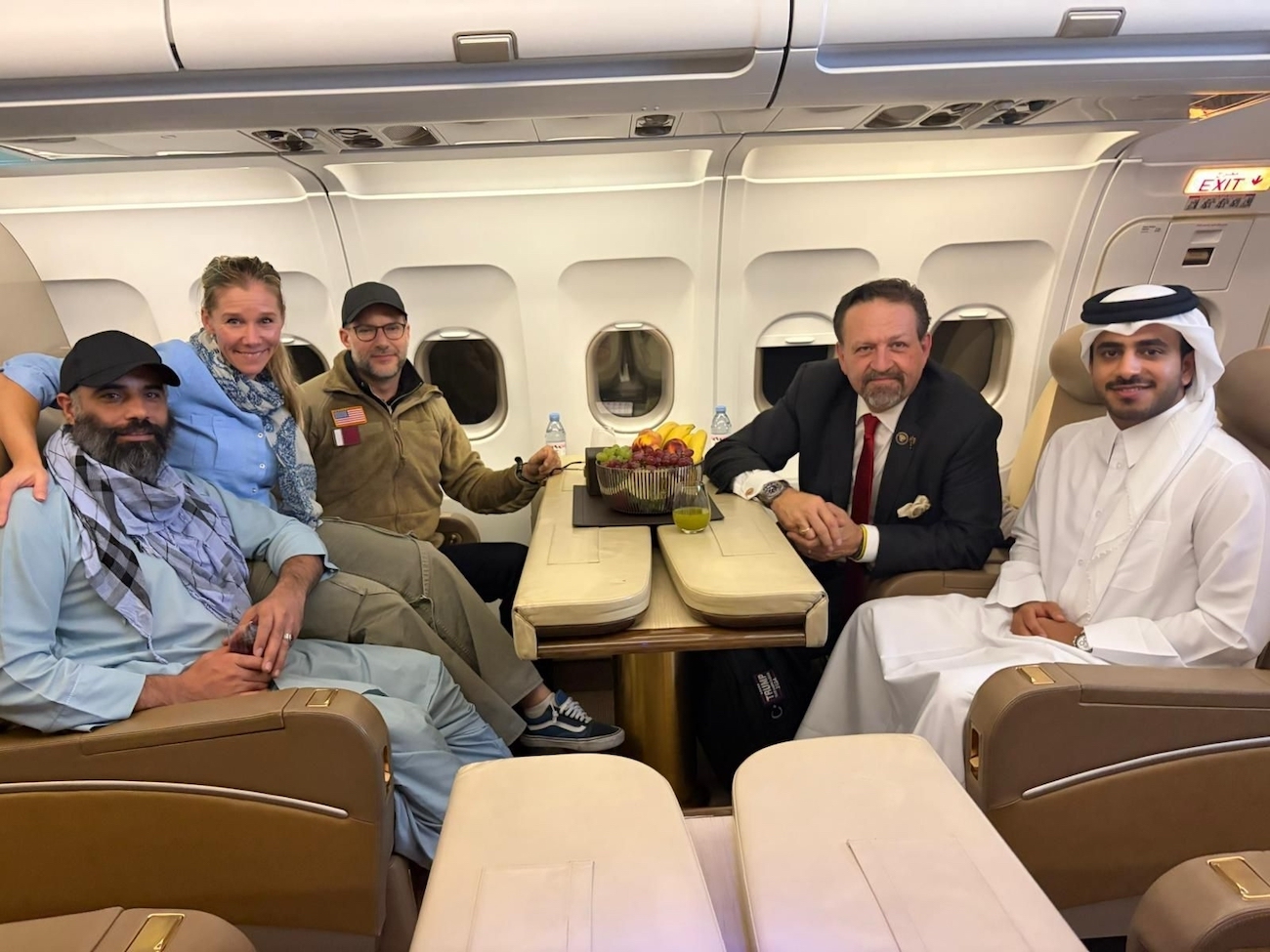 US citizen Amir Amiri, left, poses next to an unidentified woman, aboard a plane in Kabul, Afghanistan, on Sunday, Sept. 28, 2025, after being released from an Afghan prison. (Qatar Foreign Ministry)