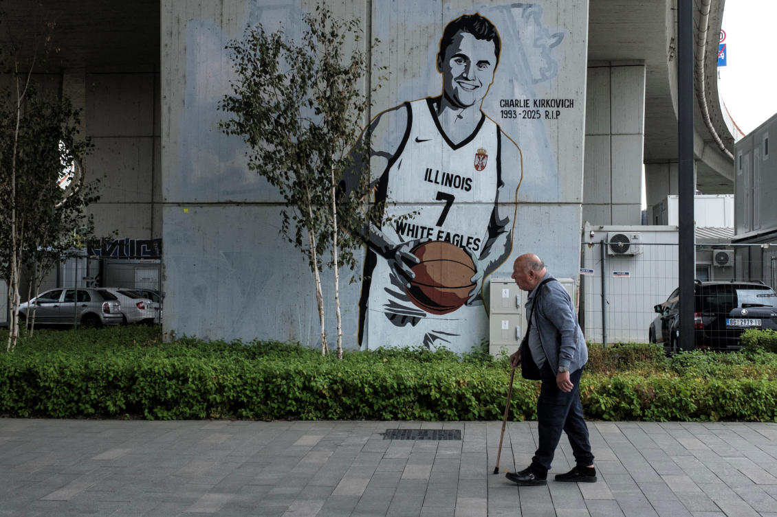 A man walks past a mural, depicting slain conservative commentator Charlie Kirk wearing an Illinois White Eagles basketball team jersey, in Belgrade, Serbia, September 26, 2025. (Reuters)