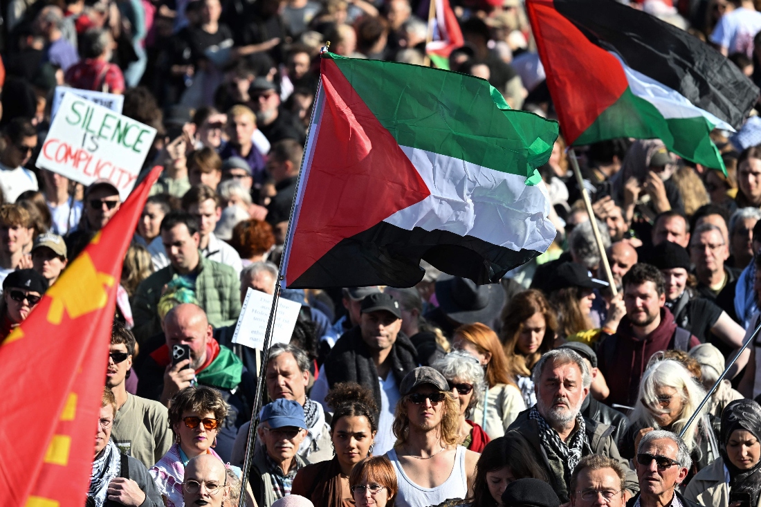 A participant displays a Palestinian flag during a demonstration under the motto 'Draw the red line with us: Together for Gaza!' in Berlin, Germany. (AFP)