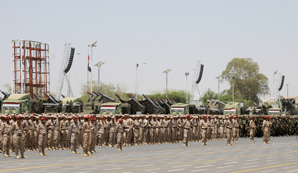 Houthi soldiers march during an official military parade marking the ninth anniversary of the Houthi takeover of the capital, Sanaa. (AFP)