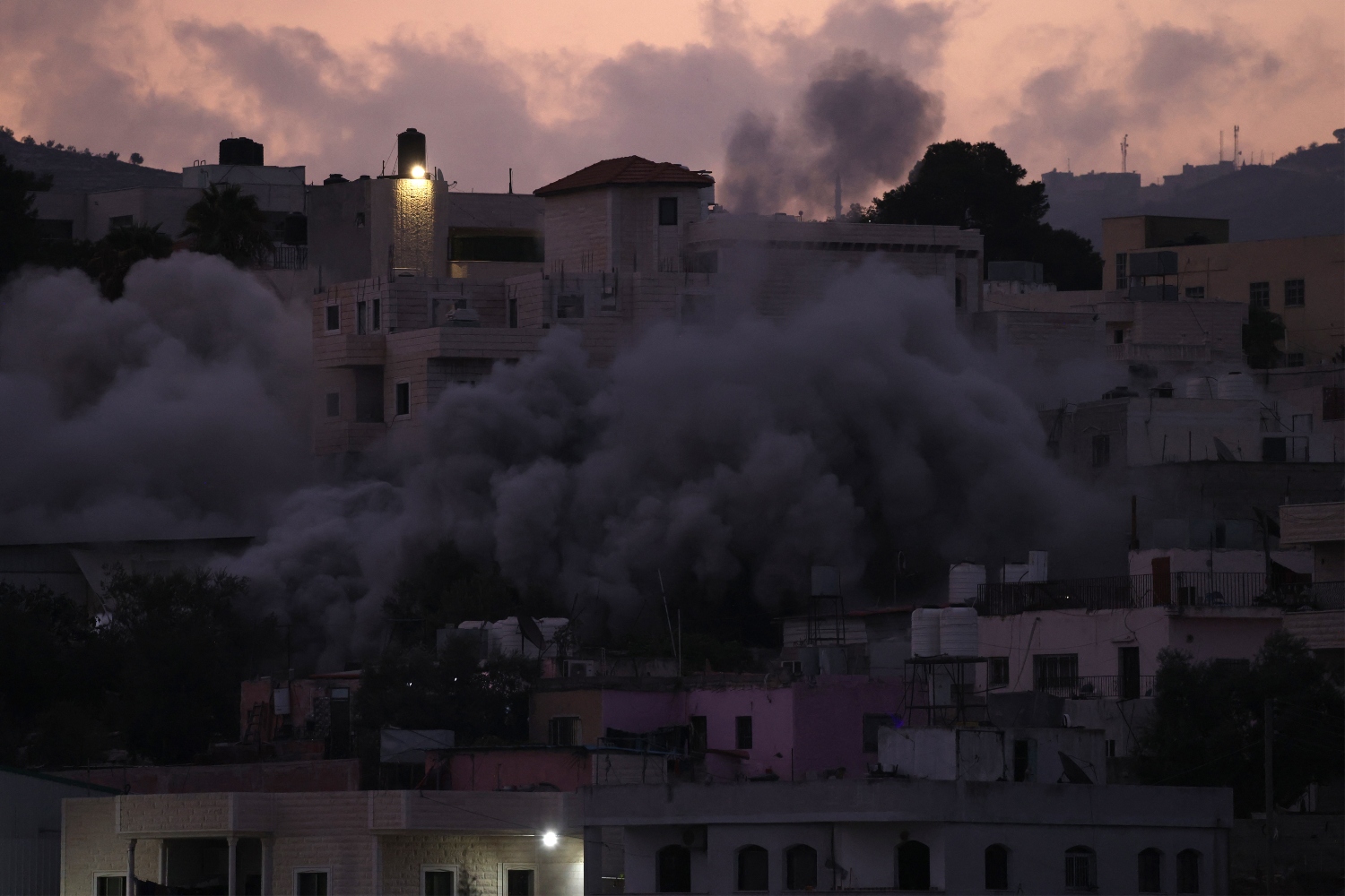Away from the cameras and headlines, Israel has launched a parallel offensive across the West Bank (File/AFP)