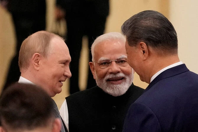 Indian Prime Minister Narendra Modi talks with Russian President Vladimir Putin and Chinese President Xi Jinping. (Reuters)