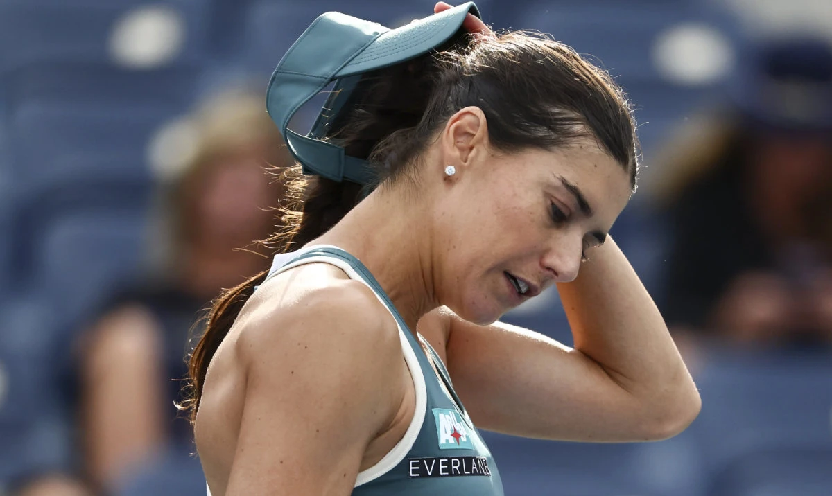 Sorana Cirstea, of Romania, pulls off her visor after losing to Karolina Muchova, of the Czech Republic, during the second round of the US Open tennis championships, Aug. 28, 2025, in New York. (AP)