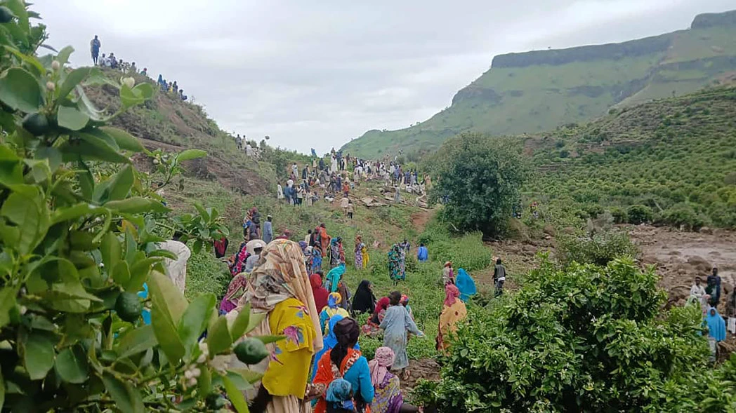 This handout image made available by the Sudan Liberation Movement/Army (SLM), on September 1, 2025, shows people inspecting the debris after a landslide devastated the village of Tarasin in Sudan's Jebel Marra area. (AFP)