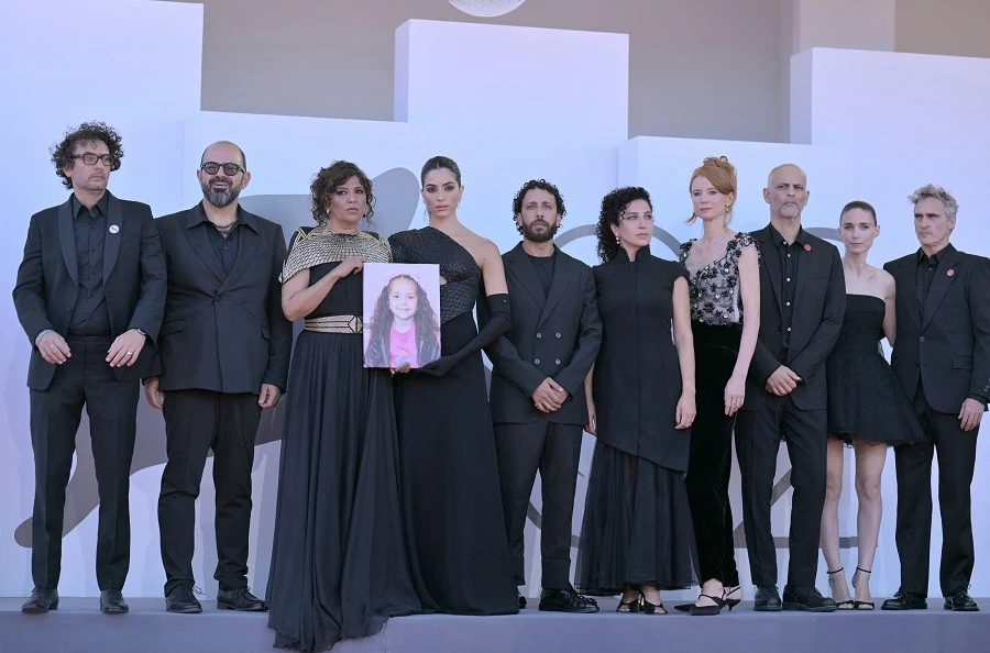 Franco-Tunisian director Kaouther Ben Hania and her cast, all dressed in black, are pictured ahead of the premiere. (AFP)