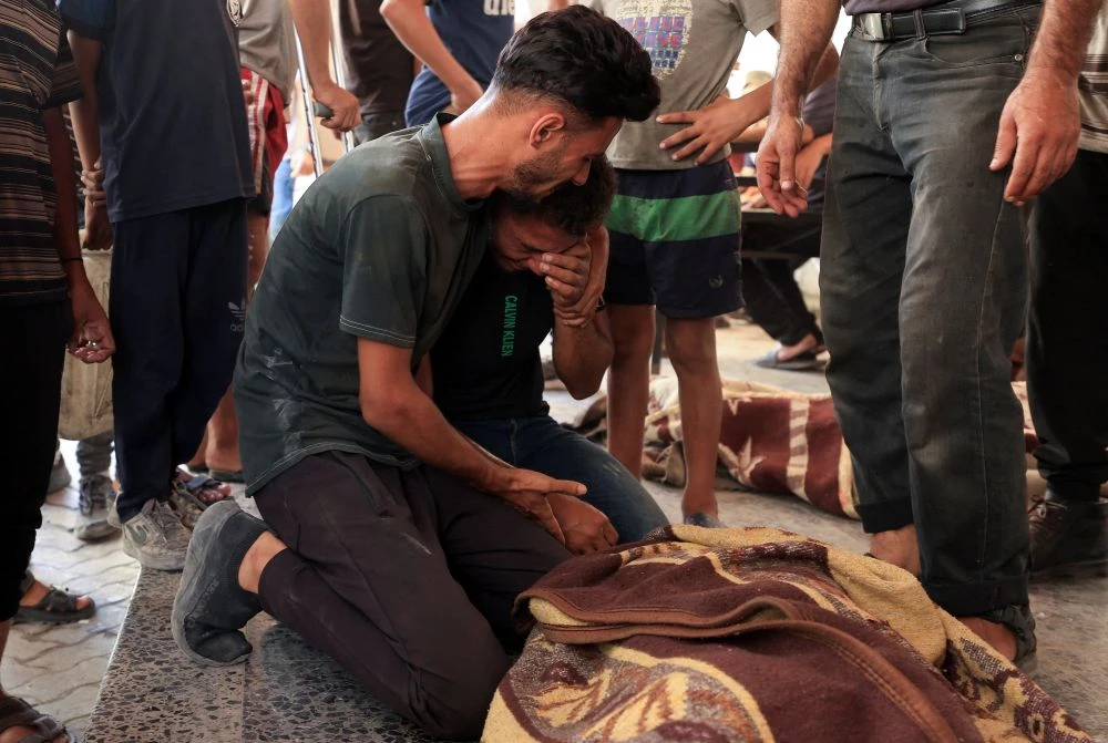 A man reacts next to a Palestinian killed in an Israeli strike at Al-Ahli Arab Hospital in Gaza City, Sept. 4, 2025. (Reuters)