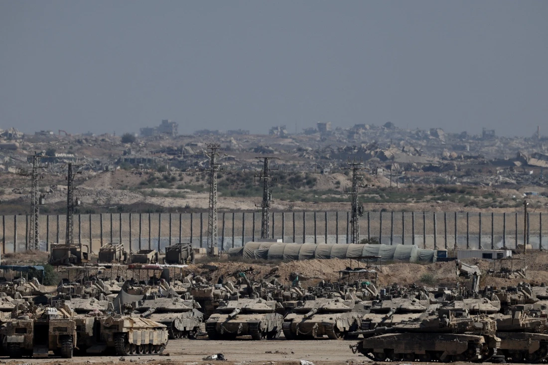 Military vehicles stand on the Israeli side of the border with Gaza. (Reuters)