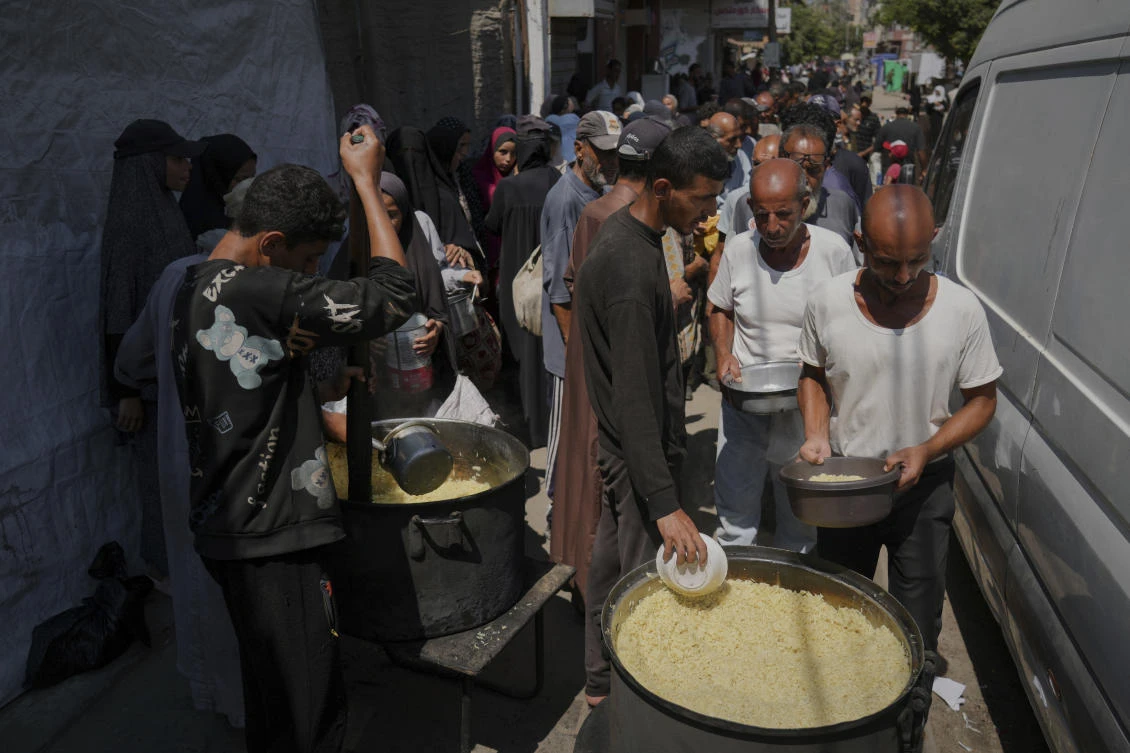 Palestinians line up to receive donated food at a community kitchen in Deir Al-Balah, southern Gaza Strip, Saturday, Sept. 6, 2025. (AP)
