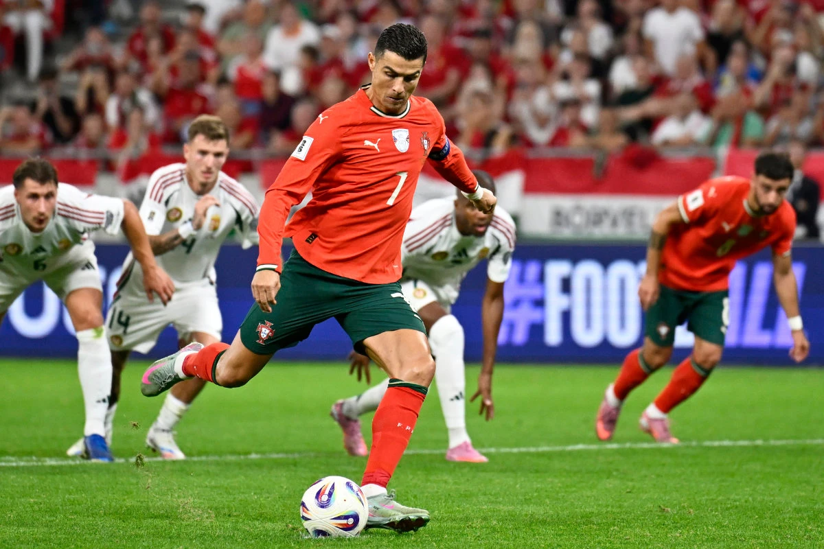 Portugal's Cristiano Ronaldo scores his side's second goal from the penalty spot during a World Cup 2026 group F qualifying soccer match between Hungary and Portugal at the Puskas Arena in Budapest, Tuesday, Sept. 9, 2025. (AP)