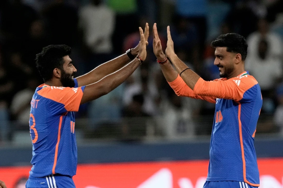 India’s Jasprit Bumrah, left, and India’s Axar Patel celebrate the wicket of United Arab Emirates’s Alishan Sharafu during the Asia Cup Cricket match between United Arab Emirates and India. (AP)