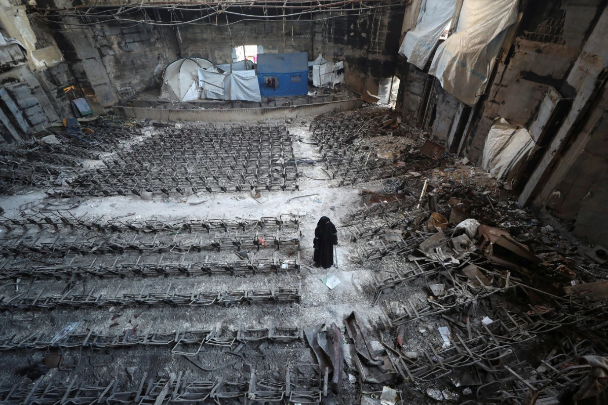 Displaced Palestinian Mervat Al-Bassiouny, whose leg was amputated due to an Israeli strike, views the damage as she shelters inside a building at the Islamic University of Gaza, from where she graduated and which was hit in previous Israeli strikes, in Gaza City April 11, 2025. (Reuters)