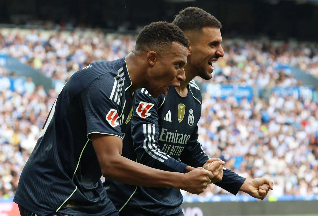 Real Madrid’s Kylian Mbappe and Dani Ceballos celebrate their second goal scored by teammate Arda Guler during their LaLiga match against Real Sociedad at Reale Arena, San Sebastian, Sept. 13, 2025. (Reuters)
