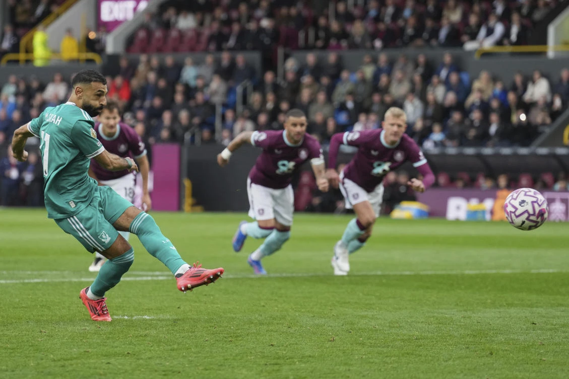 Liverpool's Mohamed Salah scores from a penalty kick during the Premier League match with Burnley. (AP)