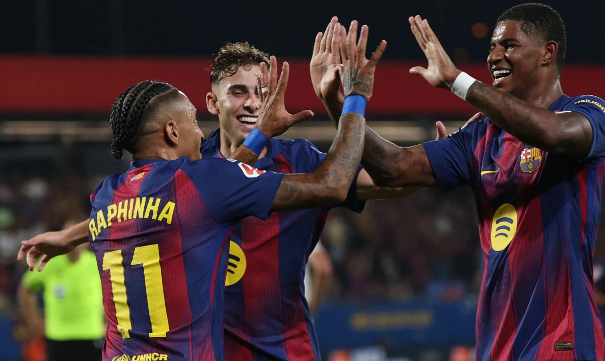 Barcelona's Brazilian forward #11 Raphinha (L) celebrates with Barcelona's English forward #14 Marcus Rashford scoring his team's second goal during the Spanish league football match between FC Barcelona and Valencia CF at Johan Cruyff Stadium in Barcelona, on September 14, 2025. (AFP)