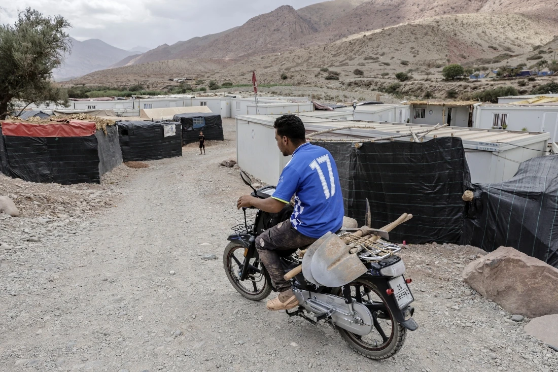 A worker rides his motorcycle to construction sites for new homes in Douar Imaounane, in Morocco's el-Haouz province. (AFP)
