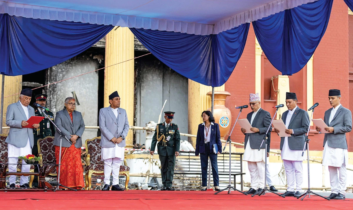 President Ram Chandra Paudel administers the oath of office to the country’s newly appointed ministers in Katmandu on Monday. (AFP)