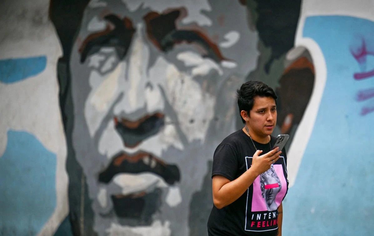 A man walks in front of a mural with an image depicting Late former Venezuela’s President Hugo Chavez in Caracas, Sept. 15, 2025. (Juan Barreto/AFP)
