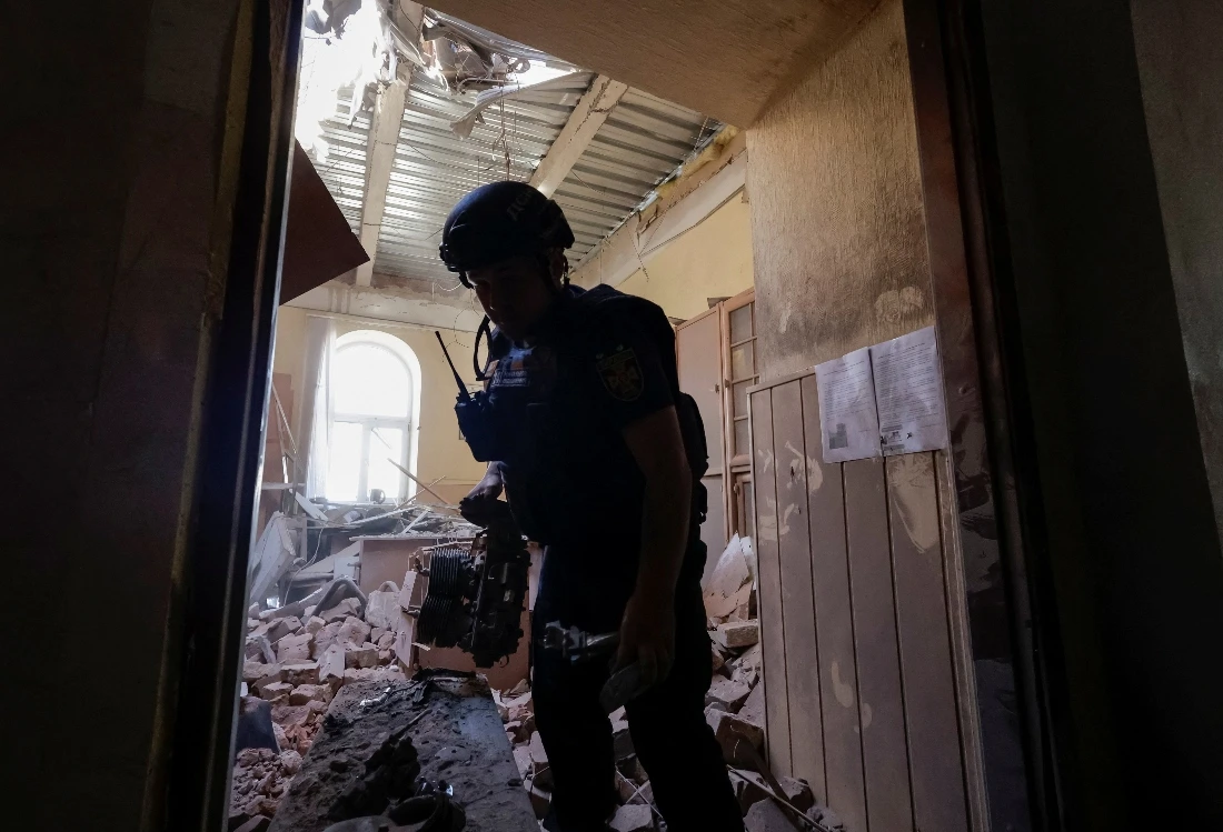 A rescuer holds an engine of Russian drone as he works at the site of a building hit during a Russian drone strike in Kharkiv, Ukraine. (Reuters)