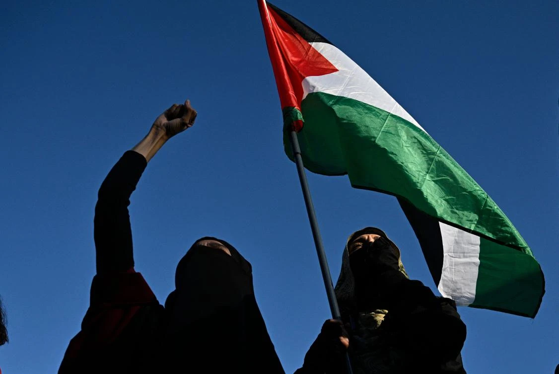 Protesters hold a Palestinian flag as they take part in the 'Stop the Genocide' rally in support of Gaza, at Place de la Republique, in Paris on September 17, 2025. (FILE/AFP)