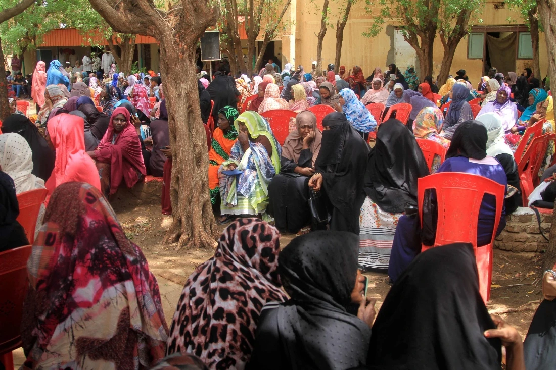 Sudanese women wait for their turn to receive humanitarian aid at a centre run by international organisations in the Hatana district of northern Khartoum. (AFP)