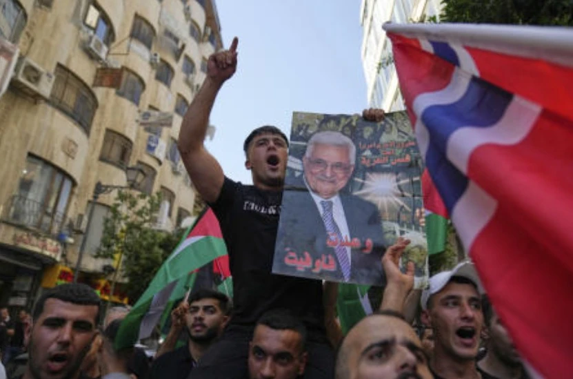 Palestinians chant national slogans and carry posters with pictures of President Mahmoud Abbas and read “you kept your promise,” during a rally in support for Gaza and celebrating the latest western nations recognitions of the Palestinian state ahead of the UNGA meetings, in Ramallah, Sept. 23, 2025. (AP)