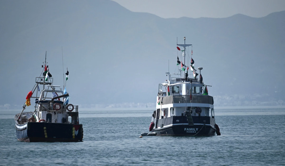 A ship (R), known as the "Family" and is part of the Global Sumud Flotilla, is anchored off the coast of the village of Sidi Bou Said on September 9, 2025. (AFP)