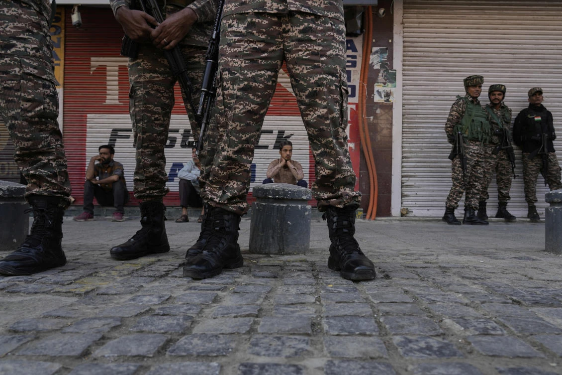 Indian security force soldiers stand guard as Kashmir civilians watch during a flag-off ceremony of the Yashasvini High-Altitude (CRPF) Bike Expedition in Srinagar, Indian controlled Kashmir, Tuesday, Sept. 23, 2025. (AP Photo/Mukhtar Khan)