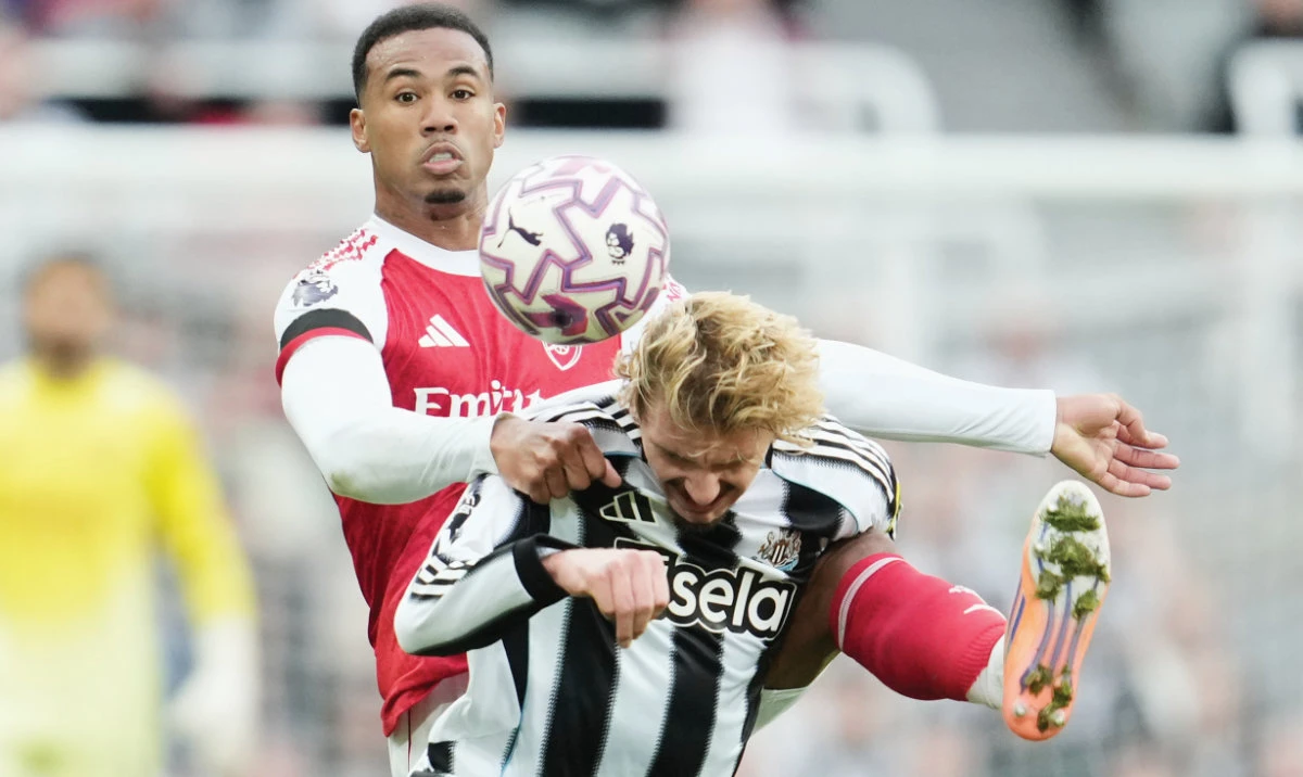 Arsenal’s Gabriel Magalhaes in action with Newcastle’s Sven Botman. (Reuters)