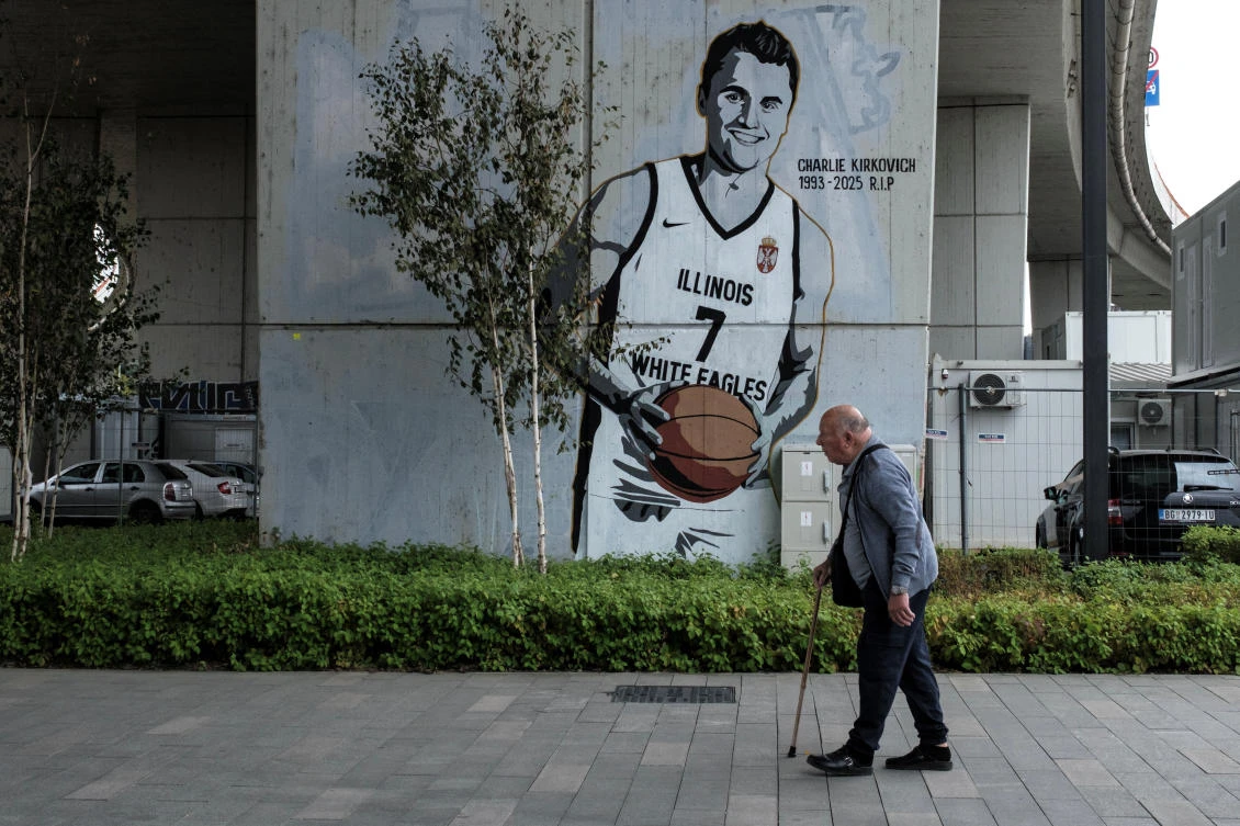 A man walks past a mural, depicting slain conservative commentator Charlie Kirk wearing an Illinois White Eagles basketball team jersey, in Belgrade, Serbia, September 26, 2025. (Reuters)