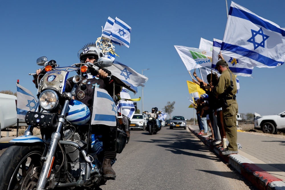 Above, mourners during a funeral procession for Israeli hostage Yossi Sharabi at Kibbutz Beeri, Israel. (Reuters)