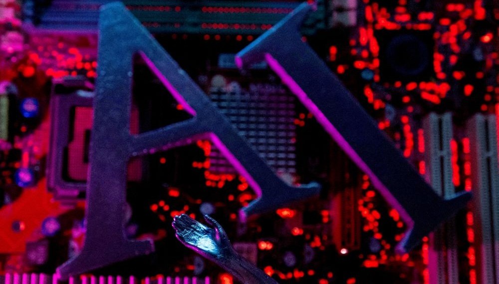 AI letters and a robot hand are placed on a computer motherboard in this illustration created on June 23, 2023. (Reuters)