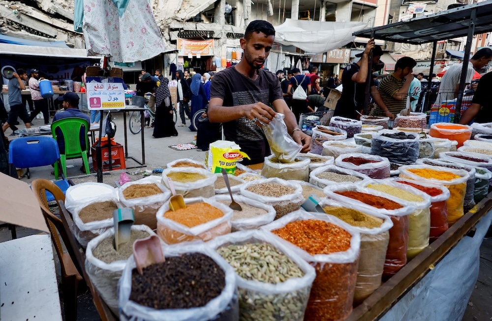 Palestinians shop at a market in Nuseirat, in the central Gaza Strip on Oct. 28, 2025. (Reuters)