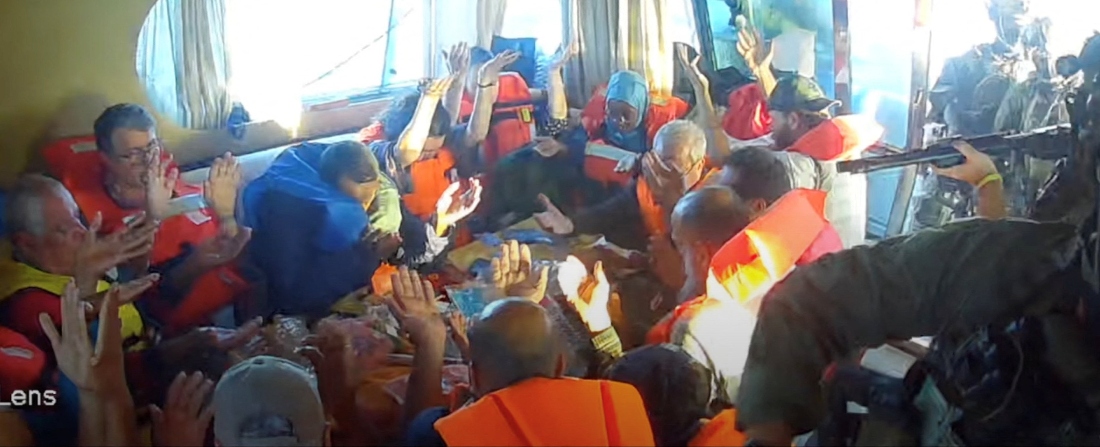 A screengrab from a live stream video shows crew raise their hands after Israeli navy forces boarded the Gaza-bound vessel Florida, part of the Global Sumud Flotilla, which flotilla organisers report has been intercepted. (Handout/Reuters)