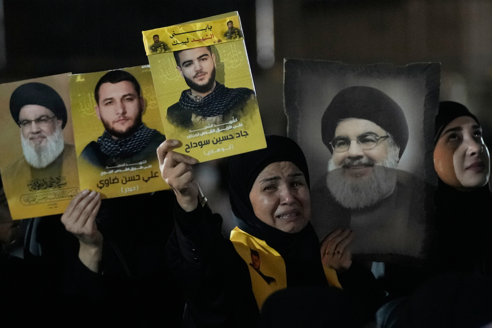People gather at the site where Hezbollah leader Hassan Nasrallah was killed in Israeli airstrikes on Sept. 27, 2024, a day before the first anniversary of his death. (AP/File Photo)