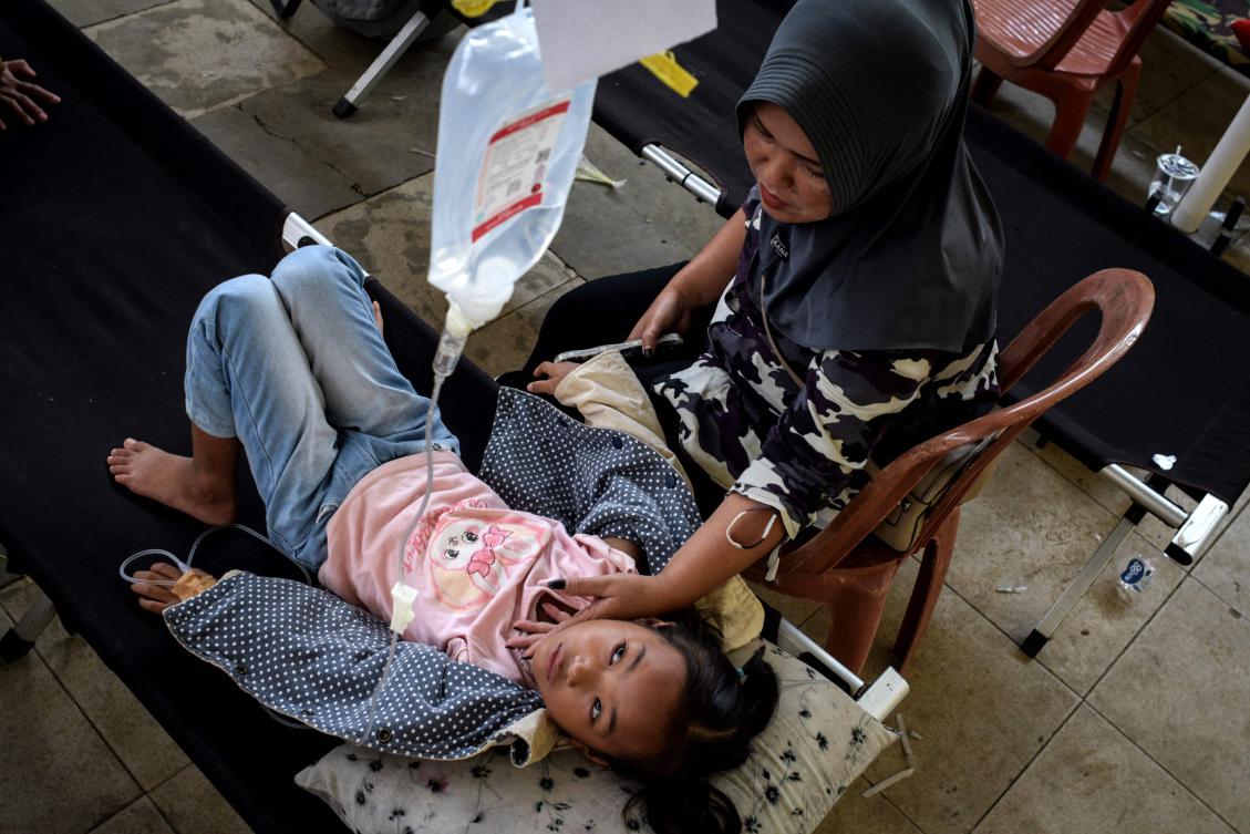 Indonesian families whose children were offered free school meals are joining non-profit groups calling for the flagship government programme to be suspended after thousands of students fell ill from the food. (AFP)