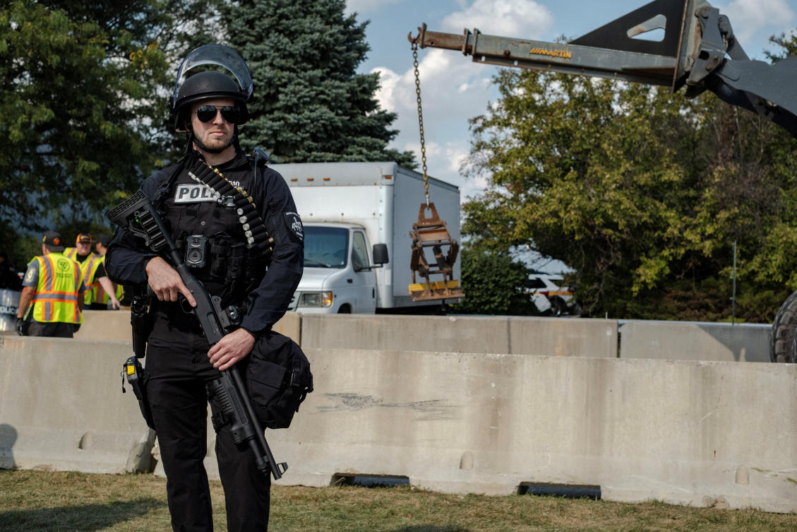 A police stands guard as workers install concrete security barriers near the Broadview ICE detention facility, after U.S. President Donald Trump ordered increased federal law enforcement presence to assist in crime prevention, in Broadview, Illinois, U.S. October 3, 2025. (Reuters)