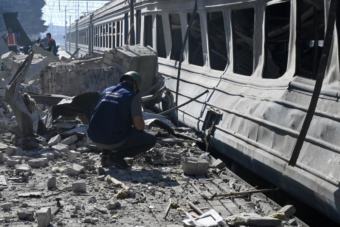 An investigator examines debris at a train station damaged following a drone strike in the town of Lozova, Kharkiv region on August 5, 2025, amid the Russian invasion of Ukraine. (FILE/AFP)