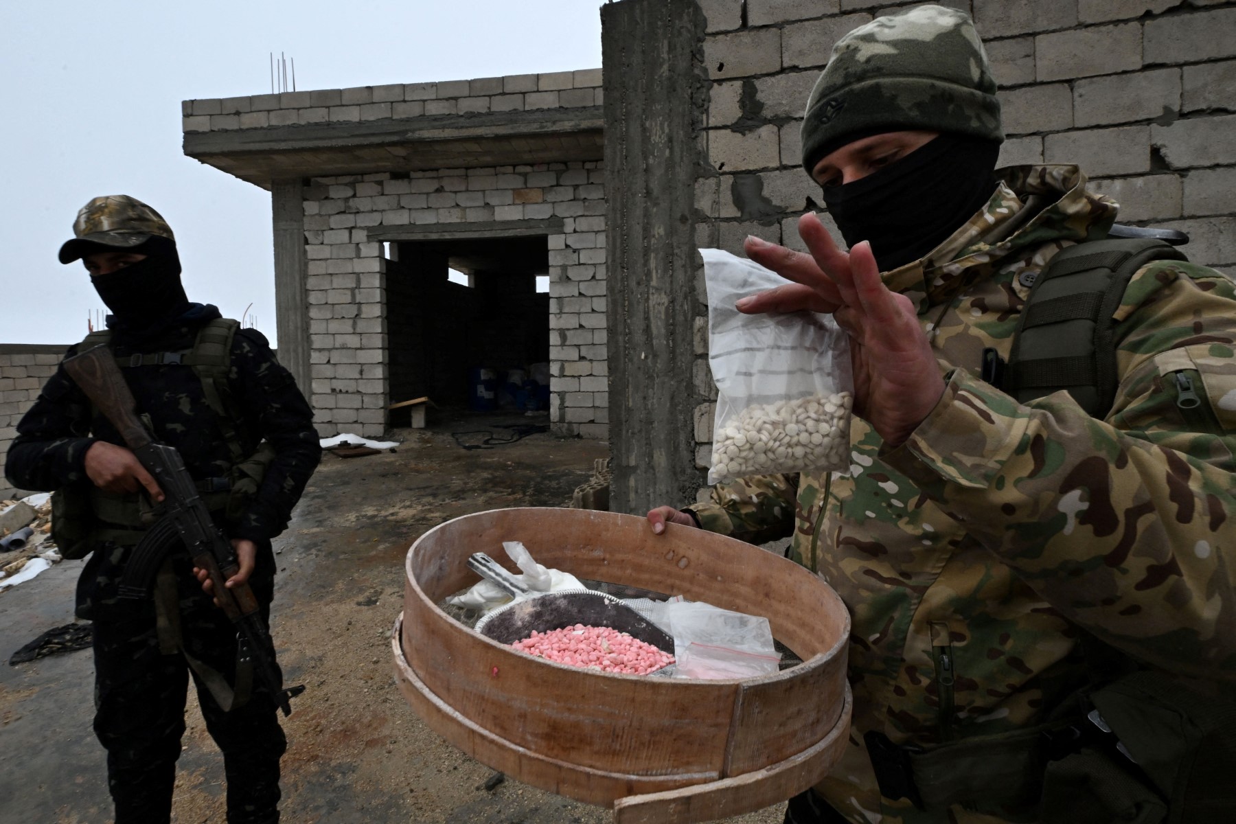Members of the Syrian security forces gather bags of narcotics at a defunct drug factory inside an abandoned building near the village of Hawik in the countryside of Al-Qusayr, Feb. 12, 2025. (File/AFP)