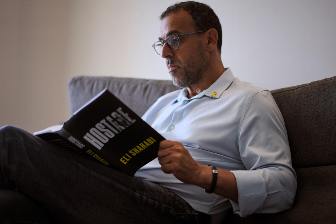 Eli Sharabi, who was abducted during the cross-border attack on Israel on Oct. 7, 2023, and held hostage by Hamas for 16 months, poses with his new book "Hostage" for a photo in Herzliya, Israel, Thursday, September 18, 2025. (AP)