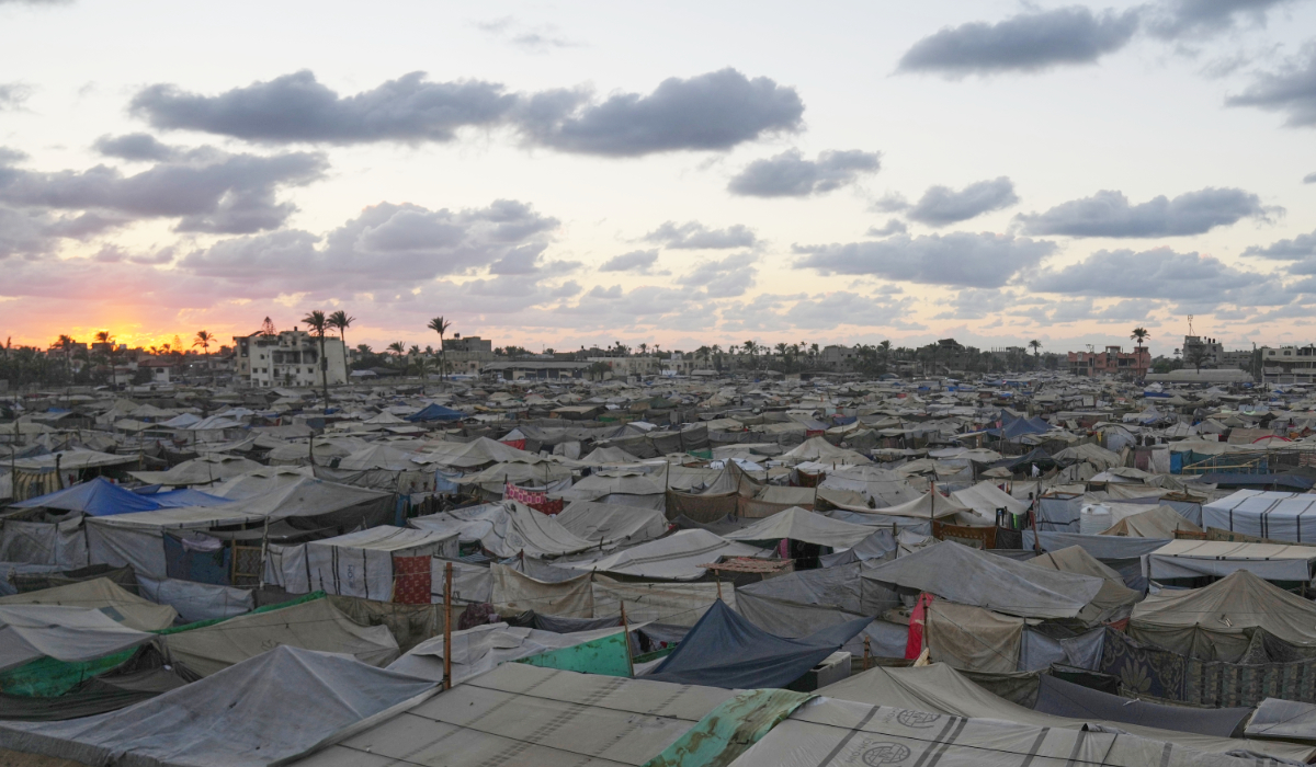 The sun sets over a temporary tent camp for displaced Palestinians in Deir Al-Balah, in the central Gaza Strip, Monday, Oct. 6, 2025. (AP)