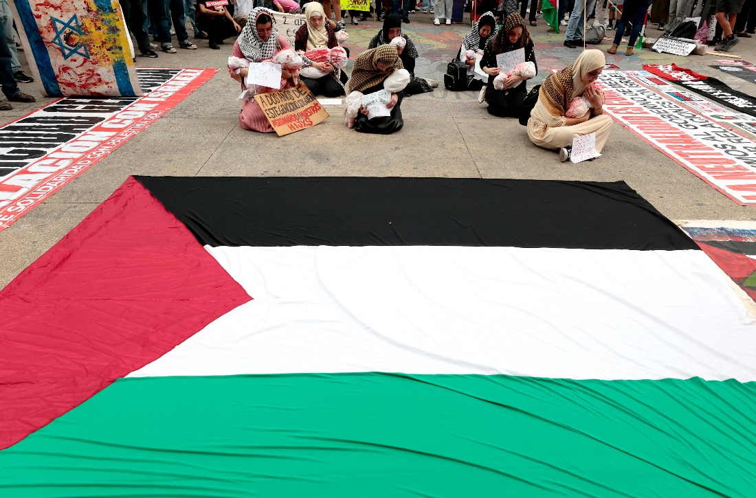Women perform a piece about children killed in Gaza during a demonstration demanding an end to attacks on the Gaza Strip and Palestinian territories as part of a national protest in Guadalajara, Mexico. (AFP)