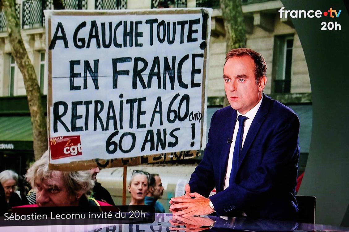 This photograph shows a television screen displaying France’s outgoing Prime Minister Sebastien Lecornu during a live broadcast interview on a set of French TV France 2 in Paris on Oct. 8, 2025. (AFP)