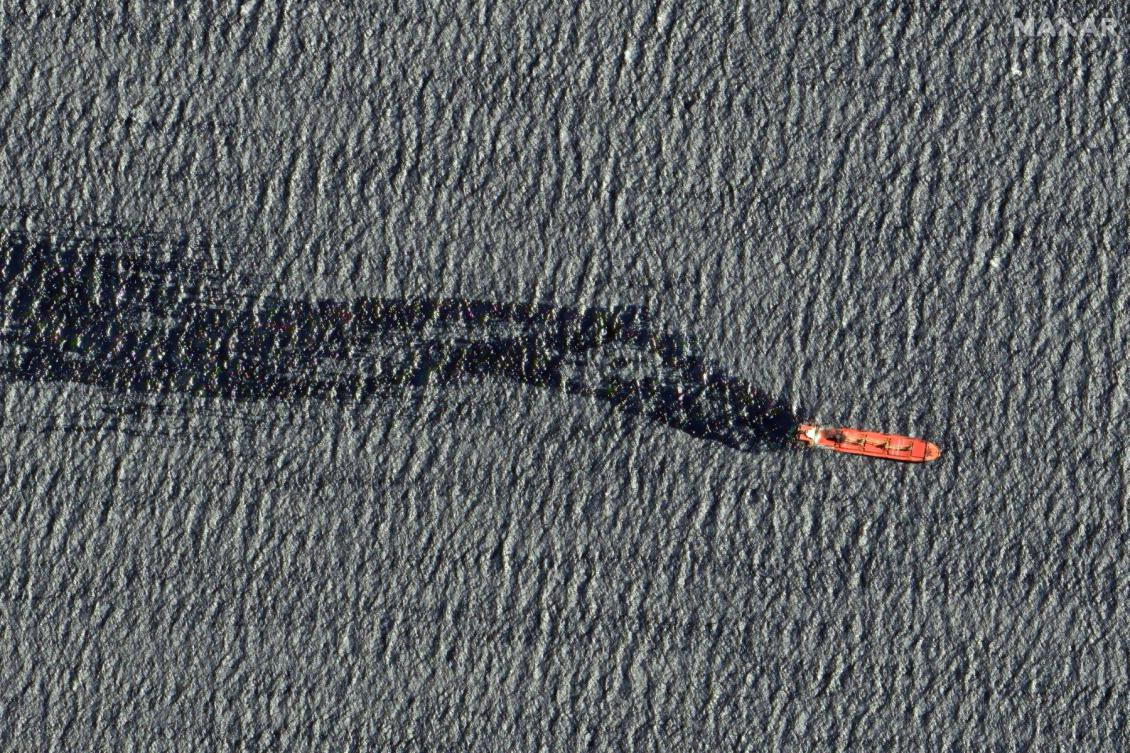 A cargo ship damaged in a February 19 missile strike claimed by the Houthis, floating in the Red Sea. (File/AFP)