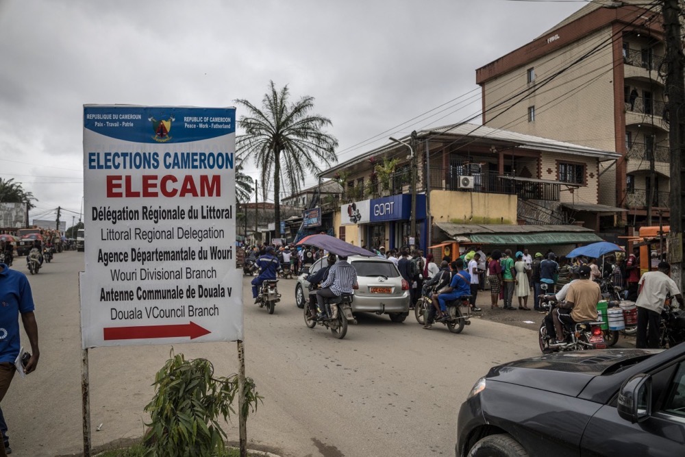 A street sign of Election Cameroon (ELECAM) is seen as Cameroonian voters queue at an office in Douala. (AFP))